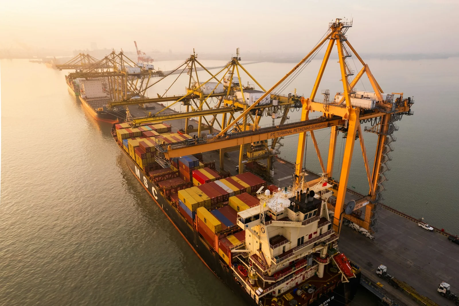 Cargo vessel moored alongside port cranes