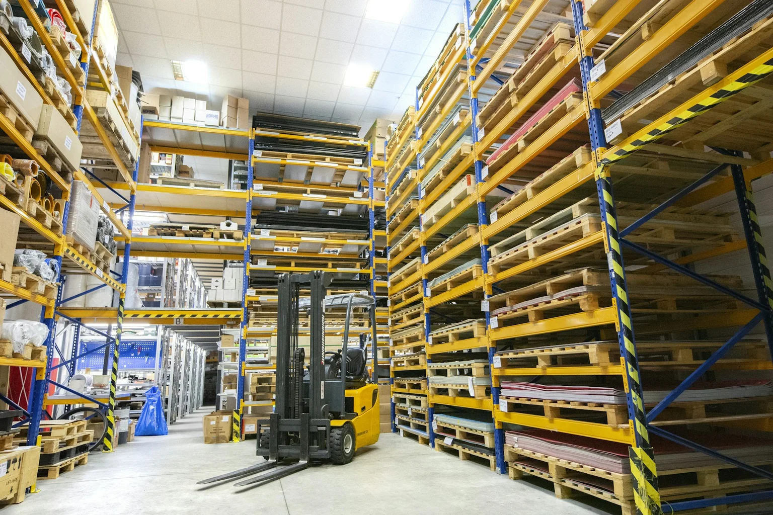 Warehouse storage racks and handling equipment